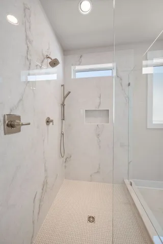 a bathroom with a bathtub and a shower