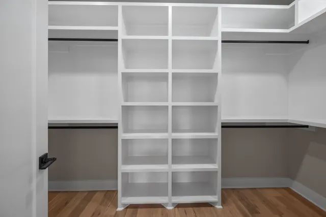 a view of walk in closet with empty racks