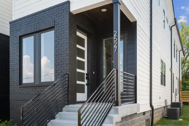 a view of a brick house with many windows