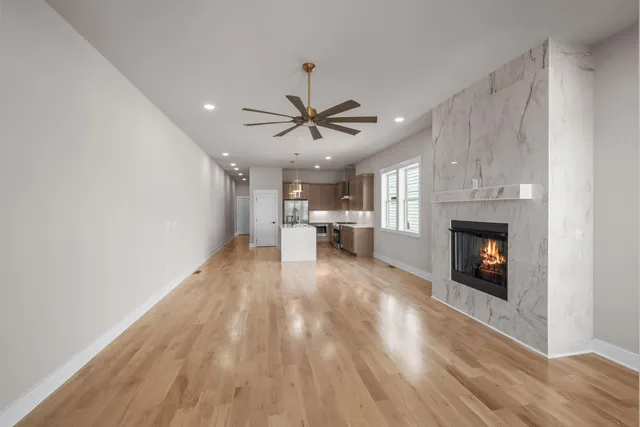a view of a livingroom with a fireplace and window