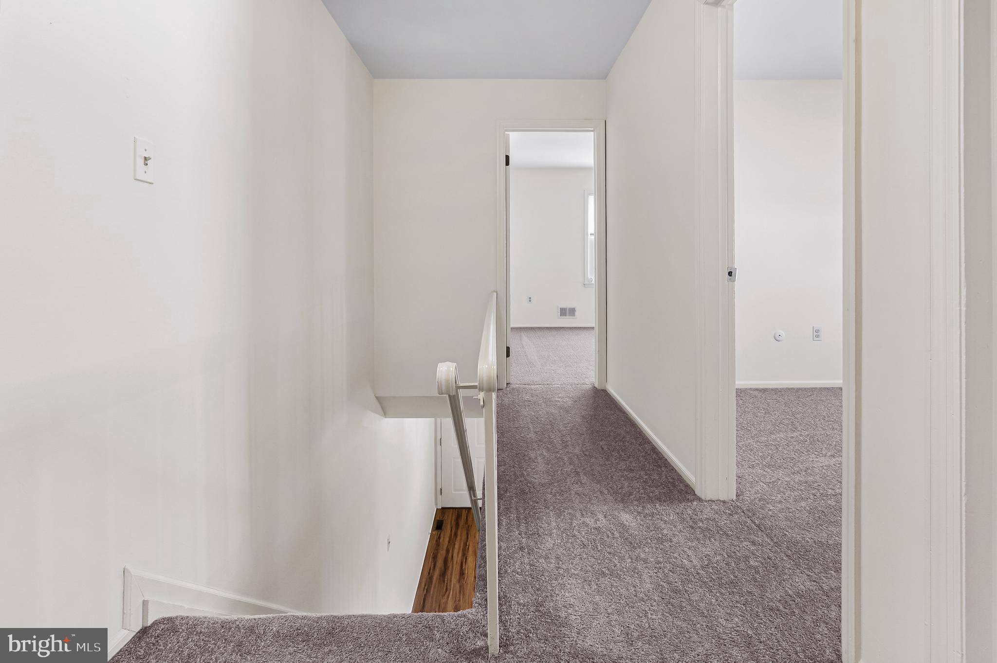 144 New Cedar Lane Hamilton, NJ 08610 - Photo 36 of 48 a view of a hallway with wooden floor and staircase