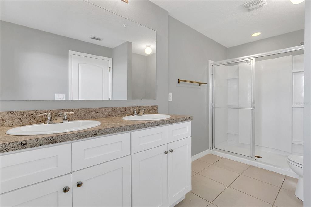 1621 Reflection Cove St. Cloud, FL 34771 - Photo 15 of 35 a bathroom with a sink and a mirror