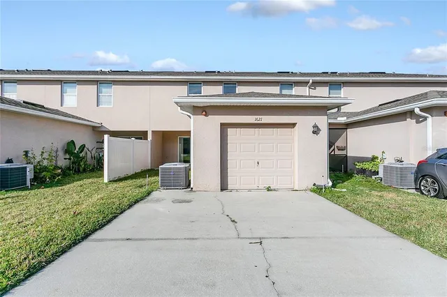 a front view of a house with a yard and garage