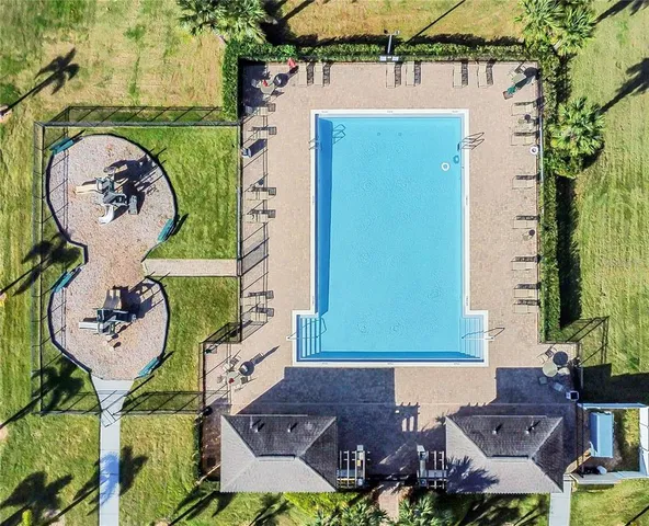 an aerial view of a town with big trees