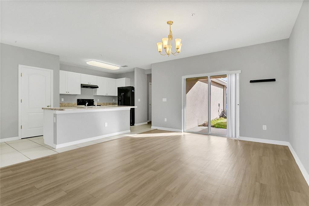 1621 Reflection Cove St. Cloud, FL 34771 - Photo 4 of 35 a view of a kitchen with microwave and cabinets