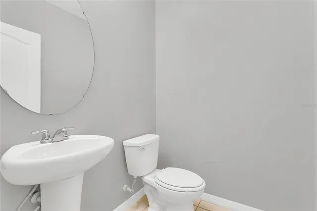 a white toilet sitting next to a white sink