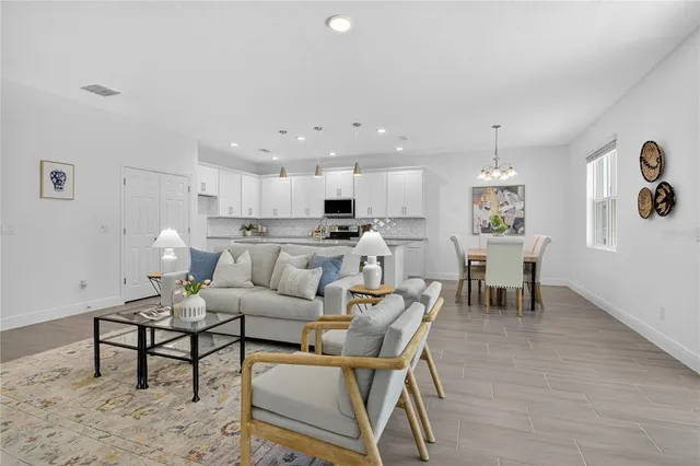 a living room with furniture and kitchen view