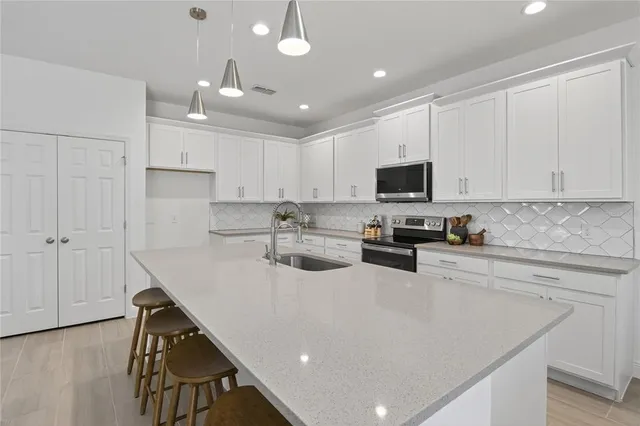 a kitchen with a sink a microwave and cabinets