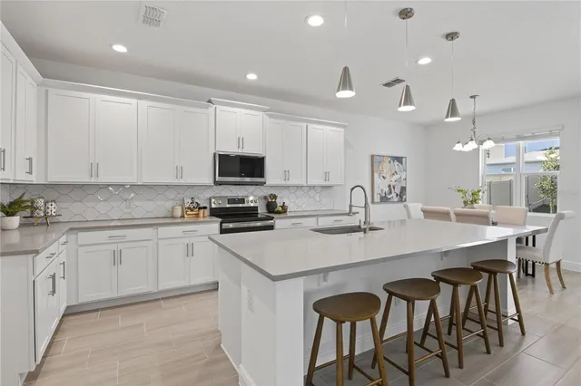 a kitchen with cabinets a sink and appliances