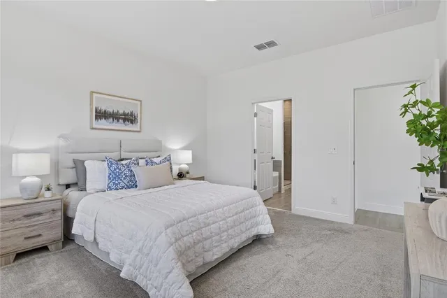 a bedroom with a bed and potted plant