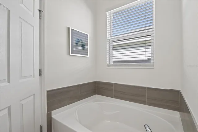 a white bath tub sitting in a bathroom