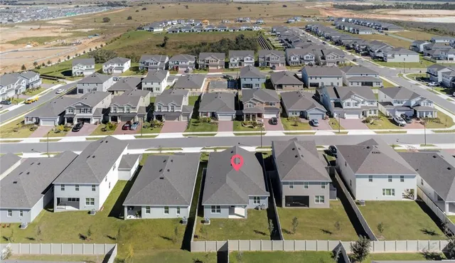 an aerial view of residential houses with outdoor space