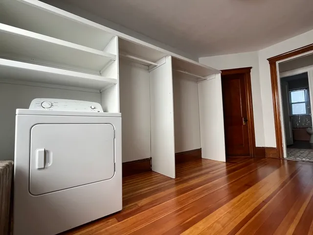a view of washer and dryer with wooden floor