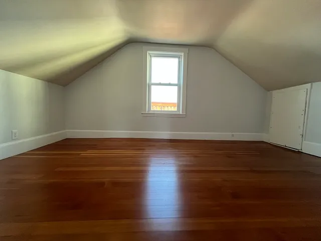 a room with wooden floor and windows
