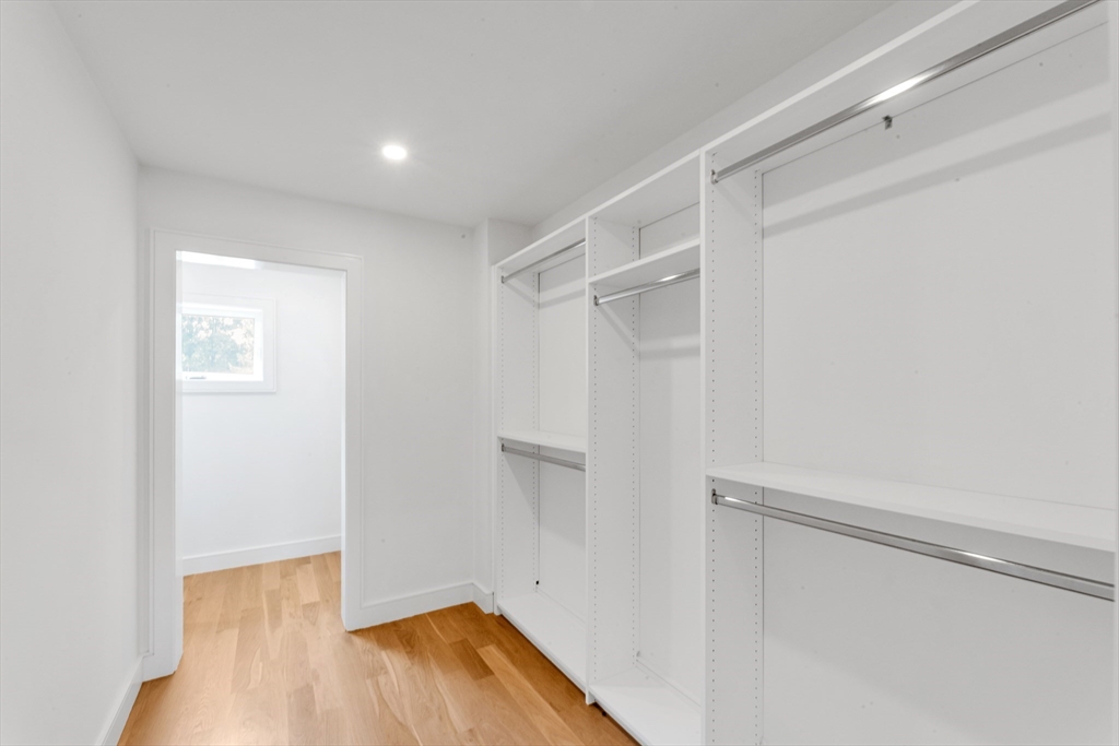 47 Corbett Avenue, Unit 47 Dedham, MA 02026 - Photo 29 of 33 a view of walk in closet with wooden floor