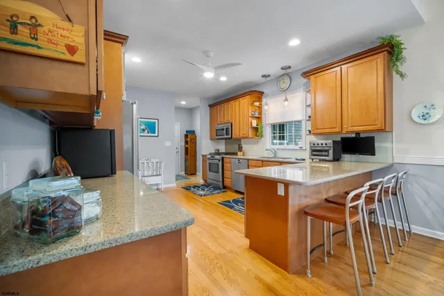 a kitchen with stainless steel appliances granite countertop sink stove top oven and cabinets