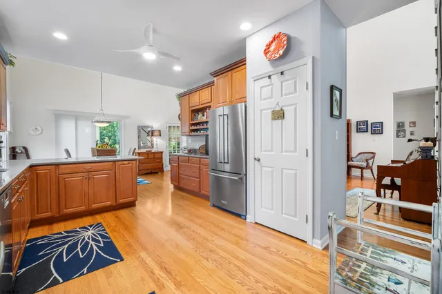a kitchen with stainless steel appliances granite countertop a refrigerator and a stove top oven