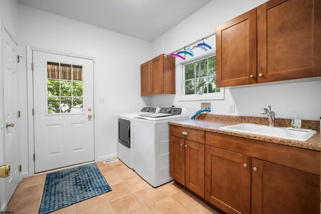 a kitchen with a sink cabinets and window