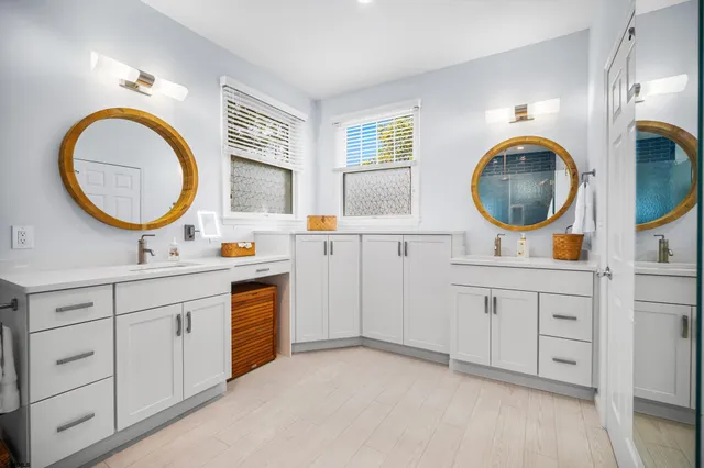 a bathroom with a sink vanity and mirror