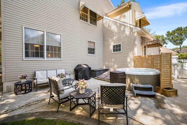 a backyard of a house with a table and chairs