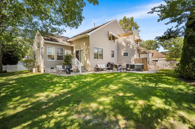 a front view of house with yard and outdoor seating
