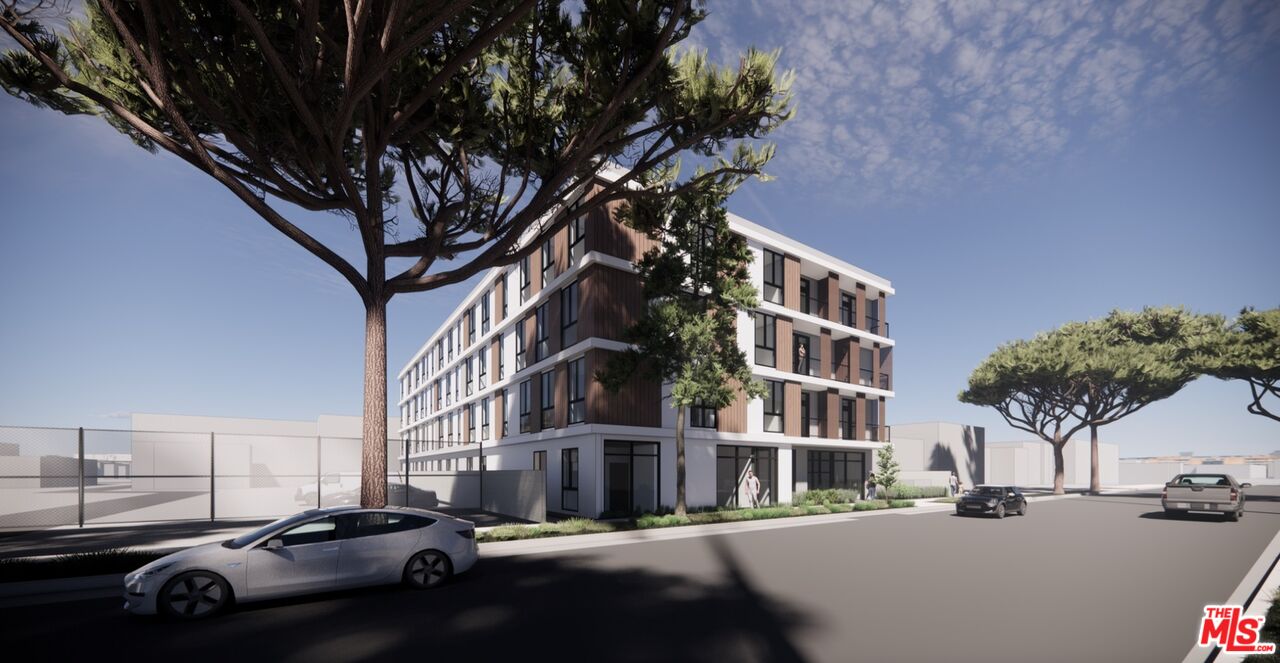 6834 Baird Avenue Reseda, CA 91335 - Photo 2 of 5 a city street lined with buildings and cars