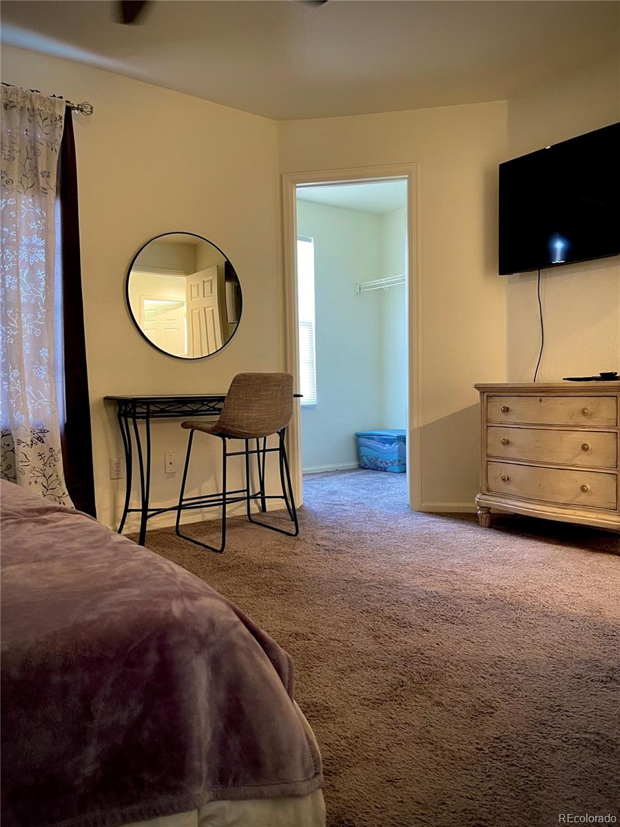 10100 Eudora Court Thornton, CO 80229 - Photo 11 of 17 a view of a livingroom with furniture and a flat screen tv