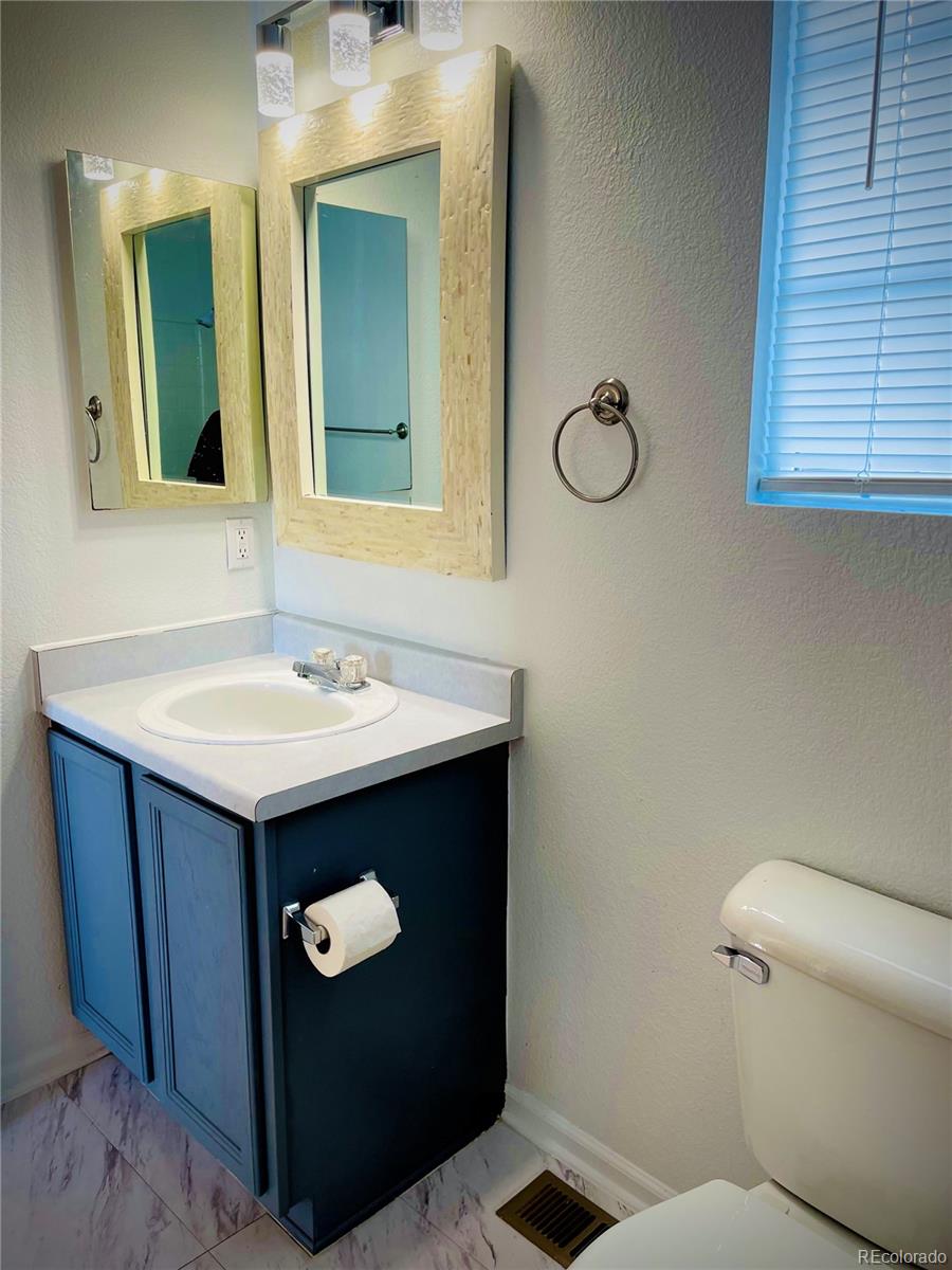 10100 Eudora Court Thornton, CO 80229 - Photo 15 of 17 a bathroom with a sink vanity and toilet