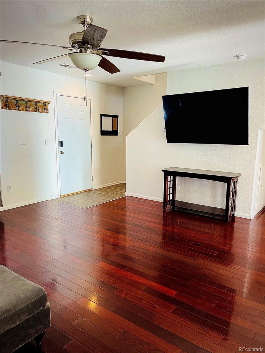 10100 Eudora Court Thornton, CO 80229 - Photo 2 of 17 a living room with furniture and a wooden floor