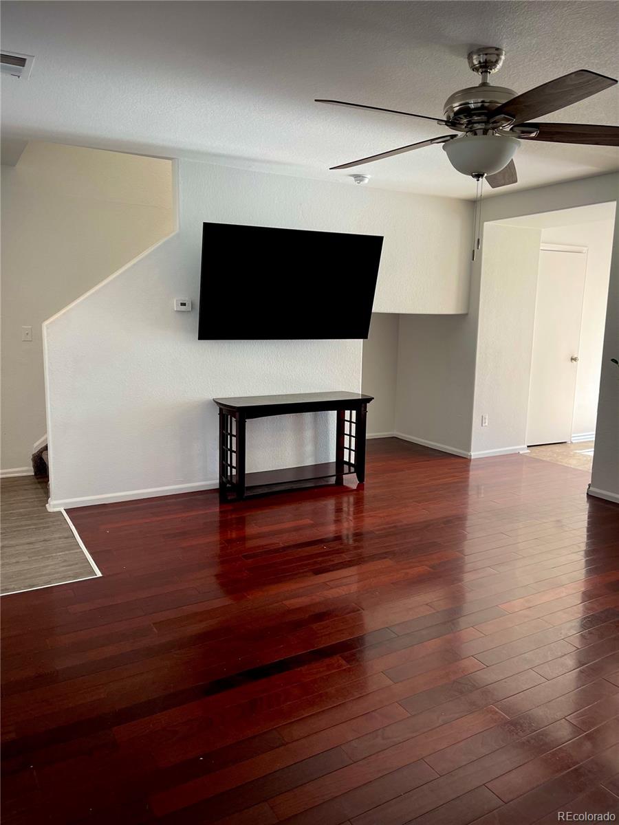 10100 Eudora Court Thornton, CO 80229 - Photo 5 of 17 a room with wooden floor and ceiling fan