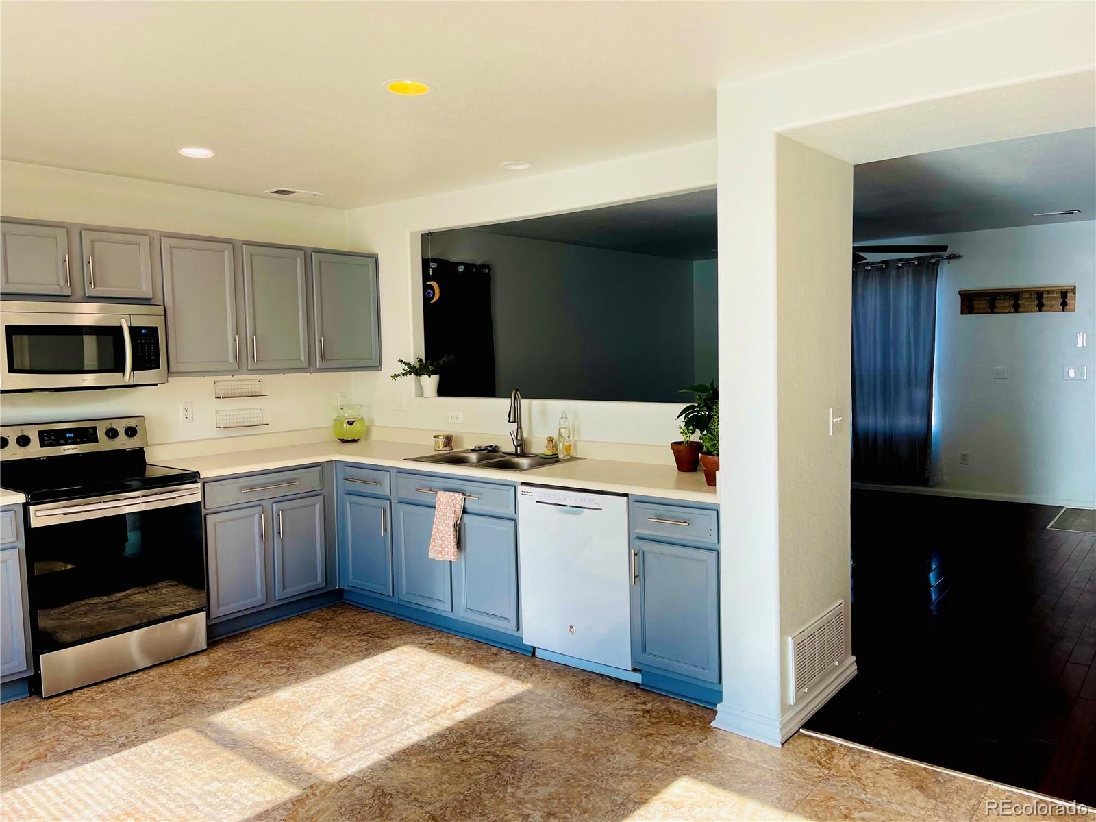 10100 Eudora Court Thornton, CO 80229 - Photo 6 of 17 a kitchen with a sink stove and microwave