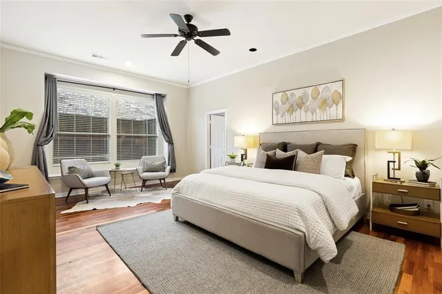 a spacious bedroom with a bed a couch and a window