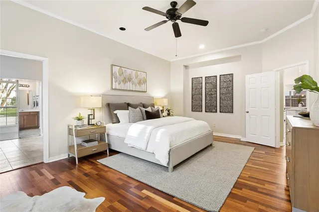 a bedroom with a large bed a rug and windows