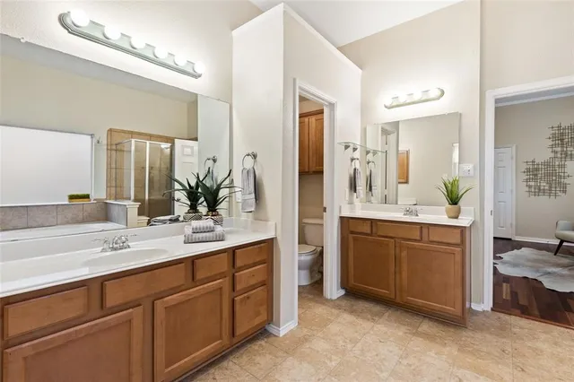 a spacious bathroom with a double vanity sink mirror and double