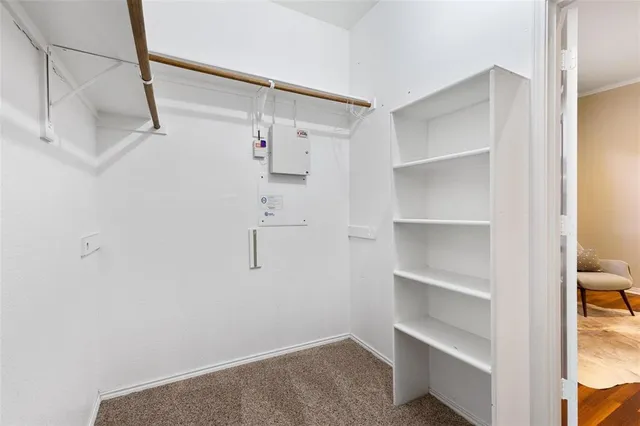 a view of walk in closet with empty racks