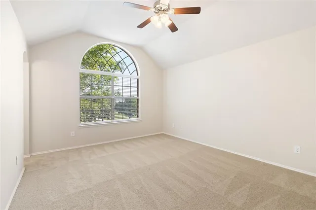 an empty room with a large window and a clock
