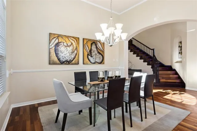 a view of a dining room with furniture wooden floor and chandelier