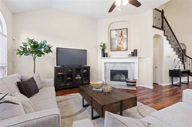 a living room with furniture a flat screen tv and a fireplace