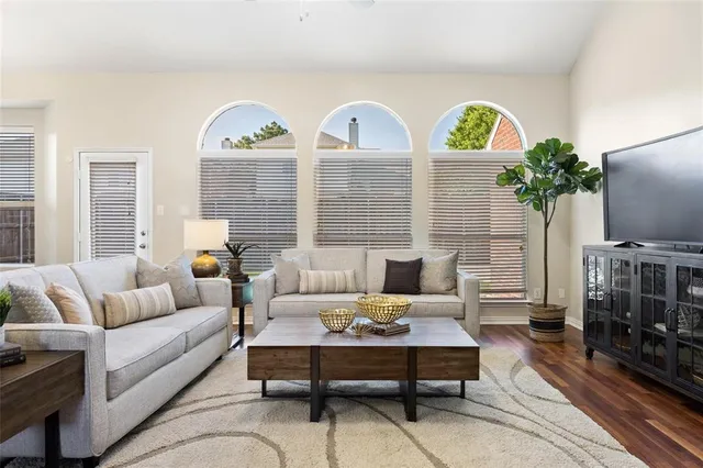 a living room with furniture a rug and a flat screen tv