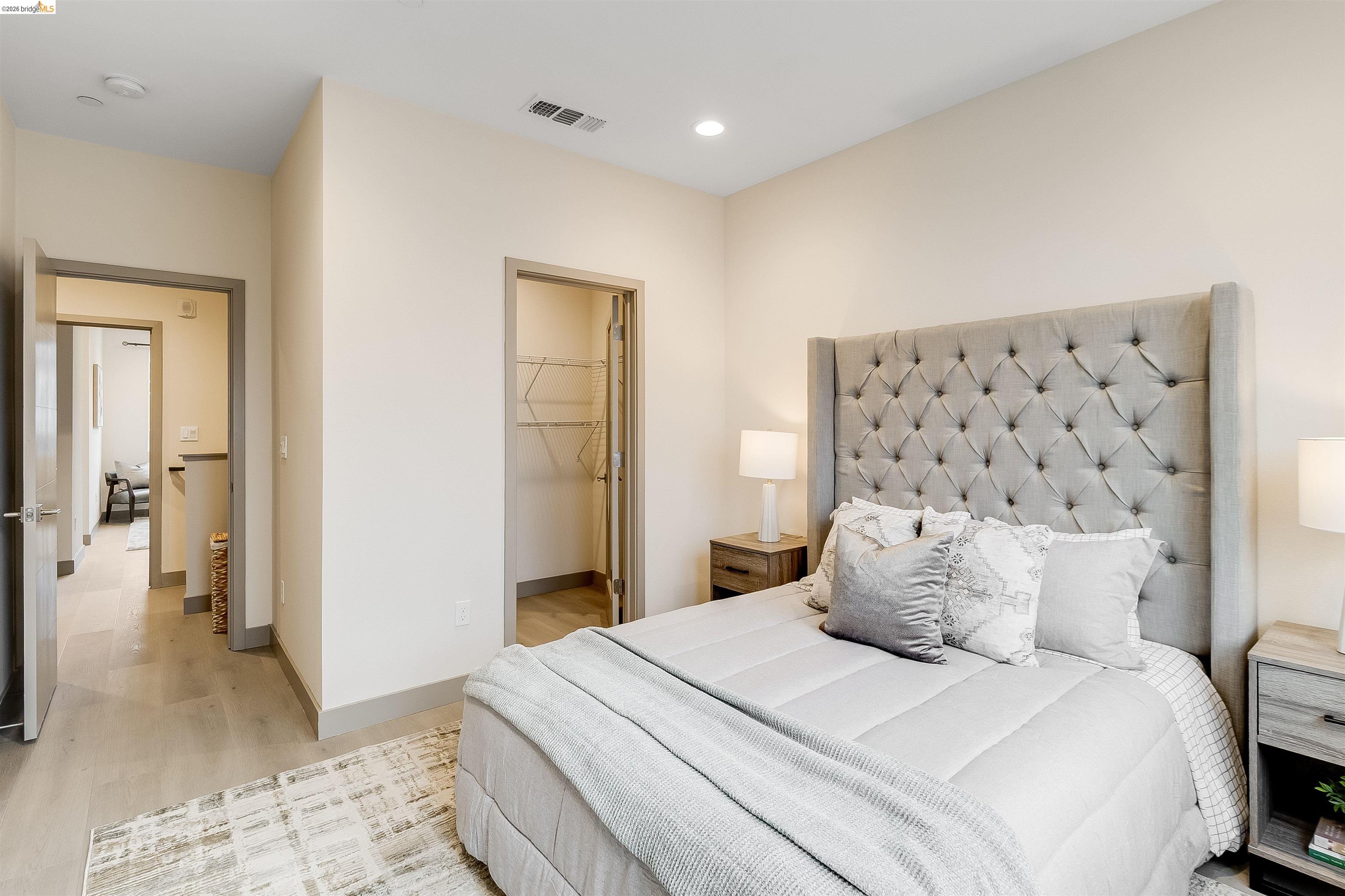 1357 Pullman Way Oakland, CA 94607 - Photo 22 of 37 Bedroom featuring light-toned walls, recessed lighting, wood-finish flooring, and a closet with wire shelving