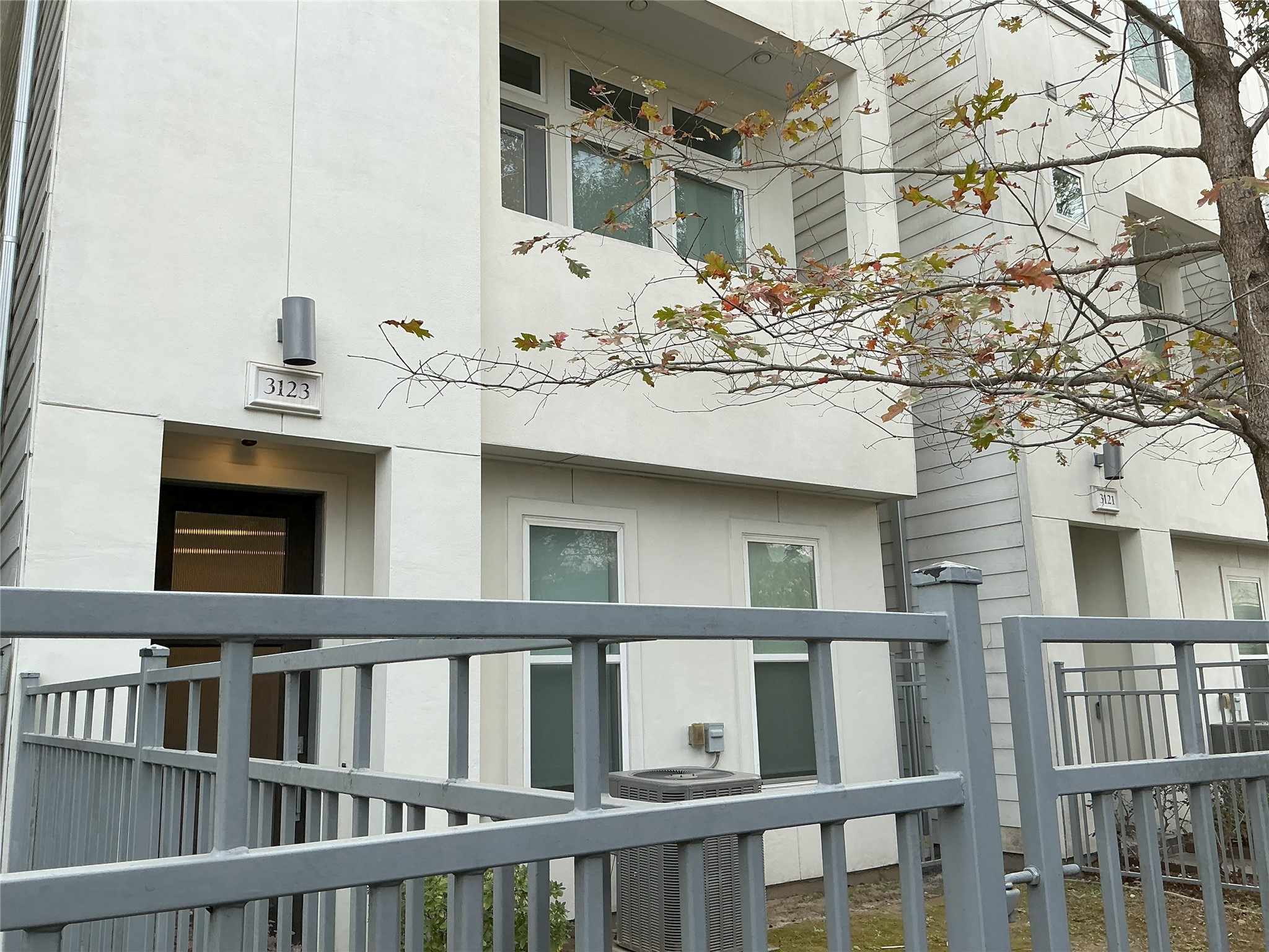 a view of a brick house with large windows and a table