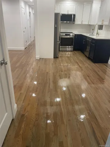 a view of kitchen with granite countertop cabinets and sink