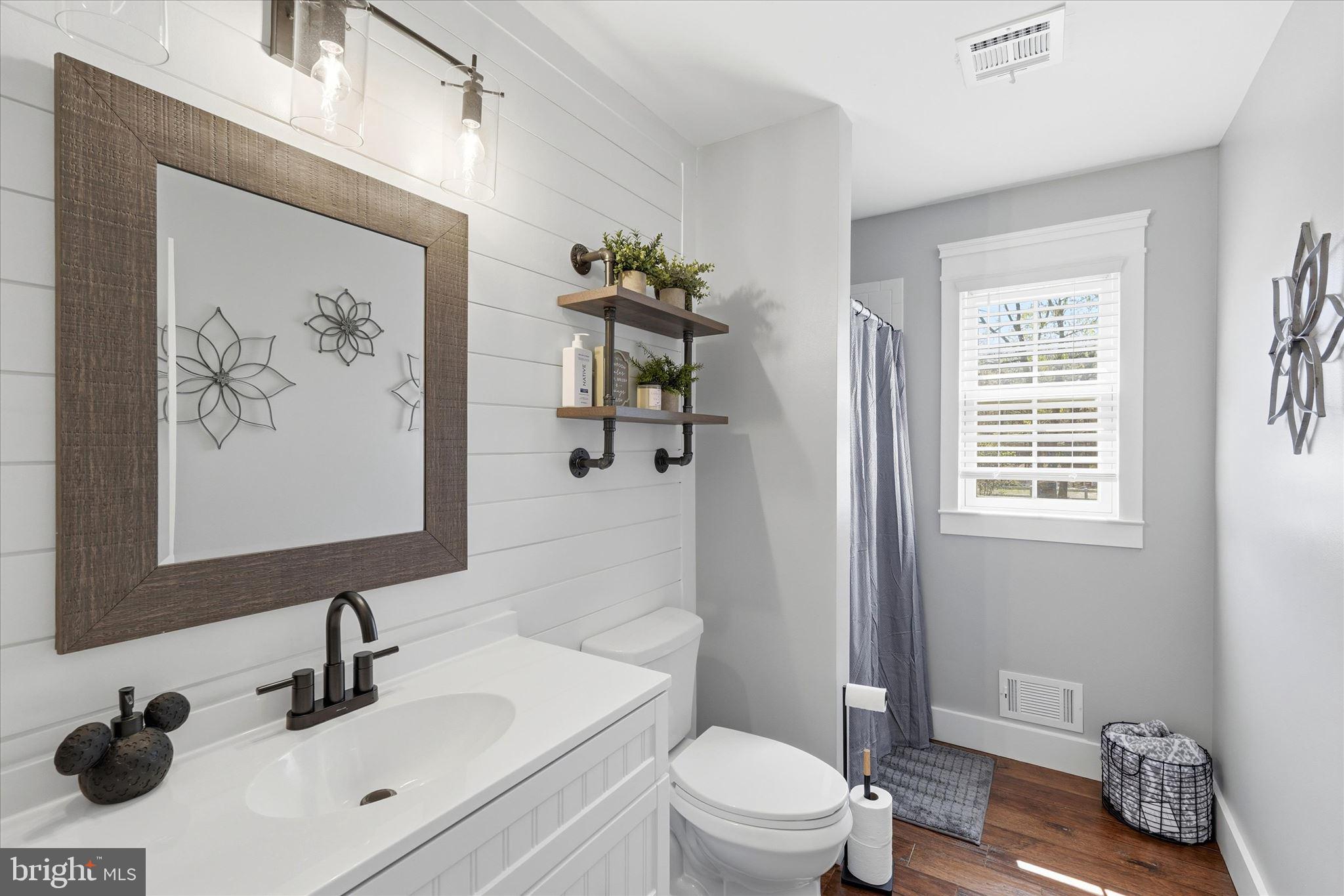 176 Warren Grove Road Barnegat, NJ 08005 - Photo 32 of 71 a bathroom with a sink a toilet and a mirror