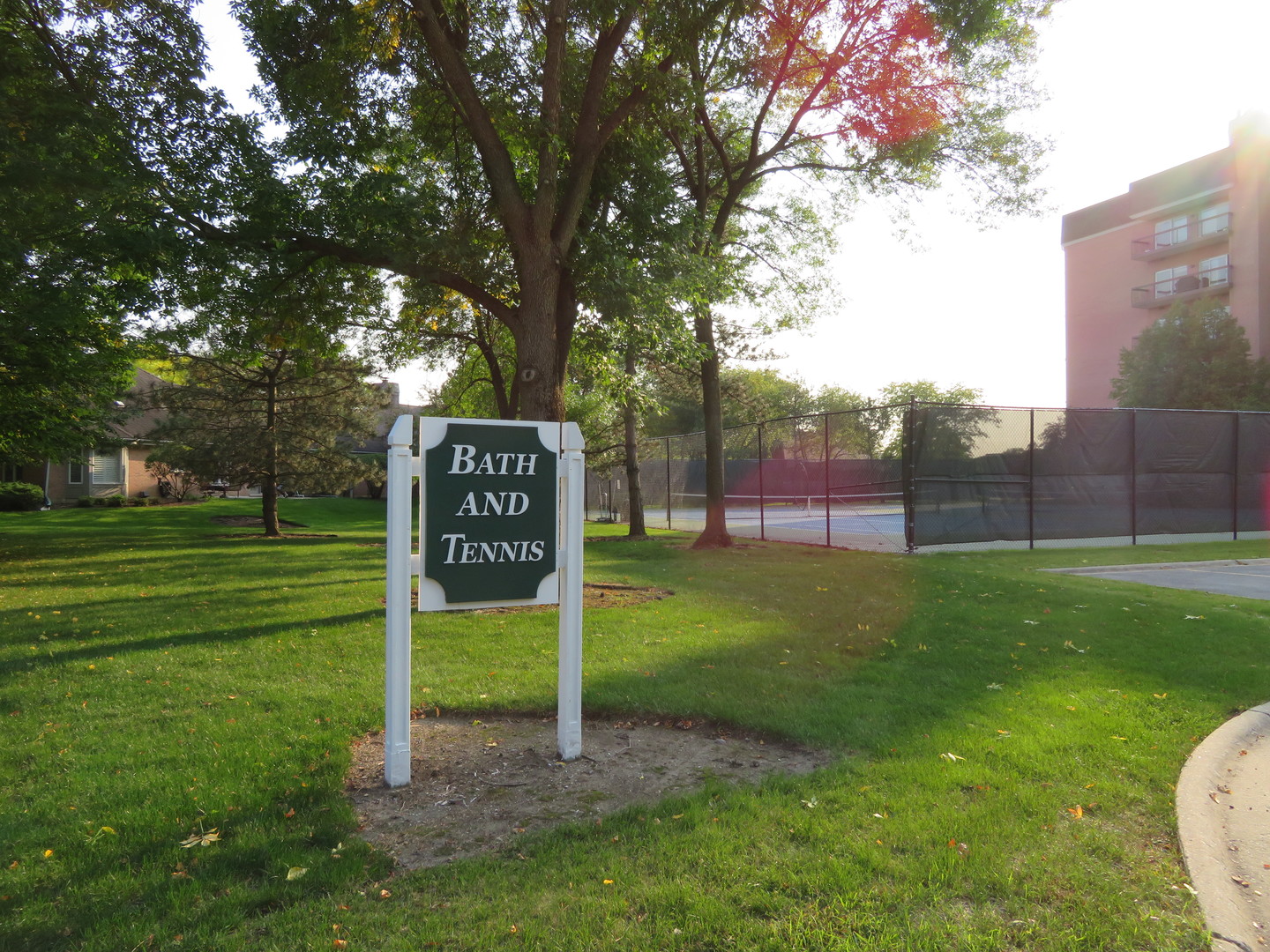 117 Rivershire Lane Lincolnshire, IL 60069 - Photo 15 of 19 a sign that is sitting in the grass near a tree