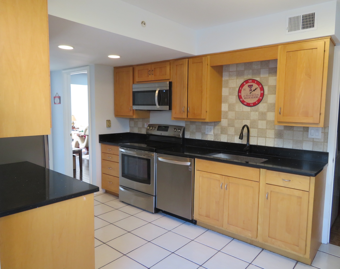 117 Rivershire Lane Lincolnshire, IL 60069 - Photo 2 of 19 a kitchen with stainless steel appliances granite countertop a sink and a microwave