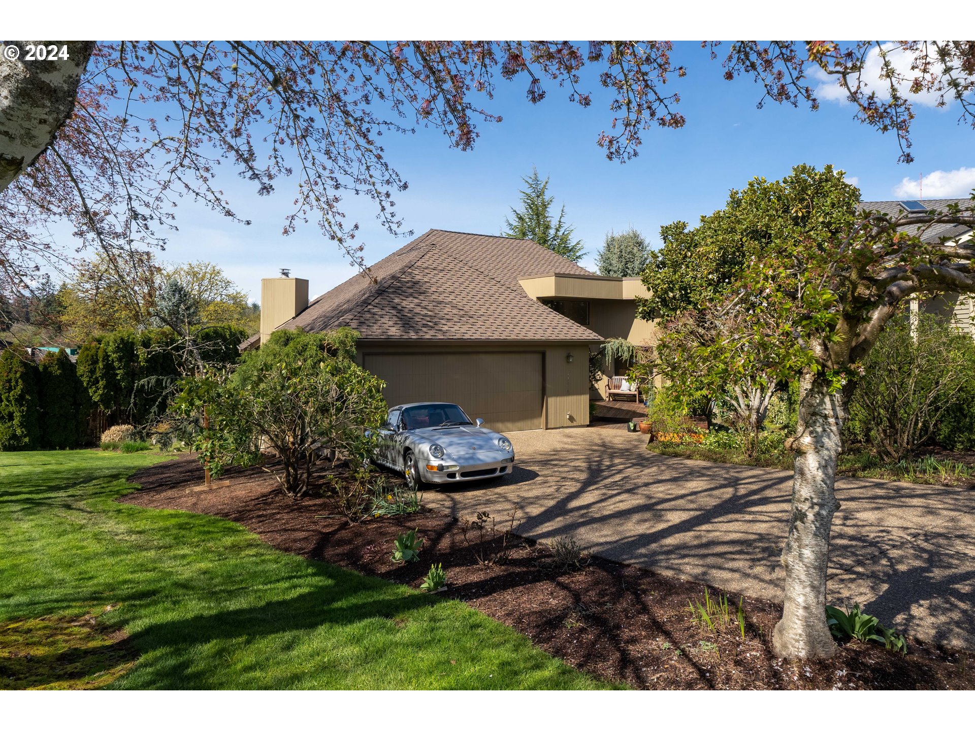 a backyard of a house with table and chairs
