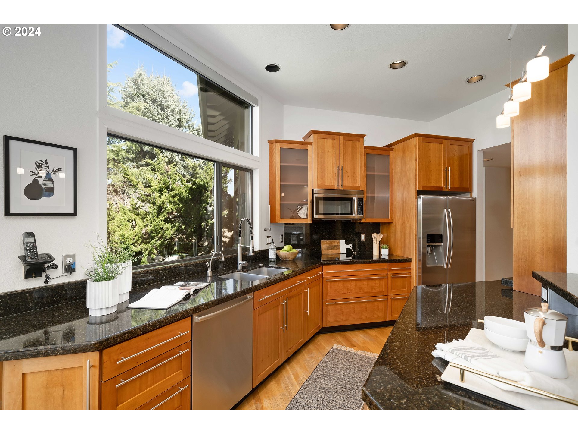 7179 Southwest Arranmore Way Portland, OR 97223 - Photo 15 of 48 a kitchen with stainless steel appliances a sink counter space and a window