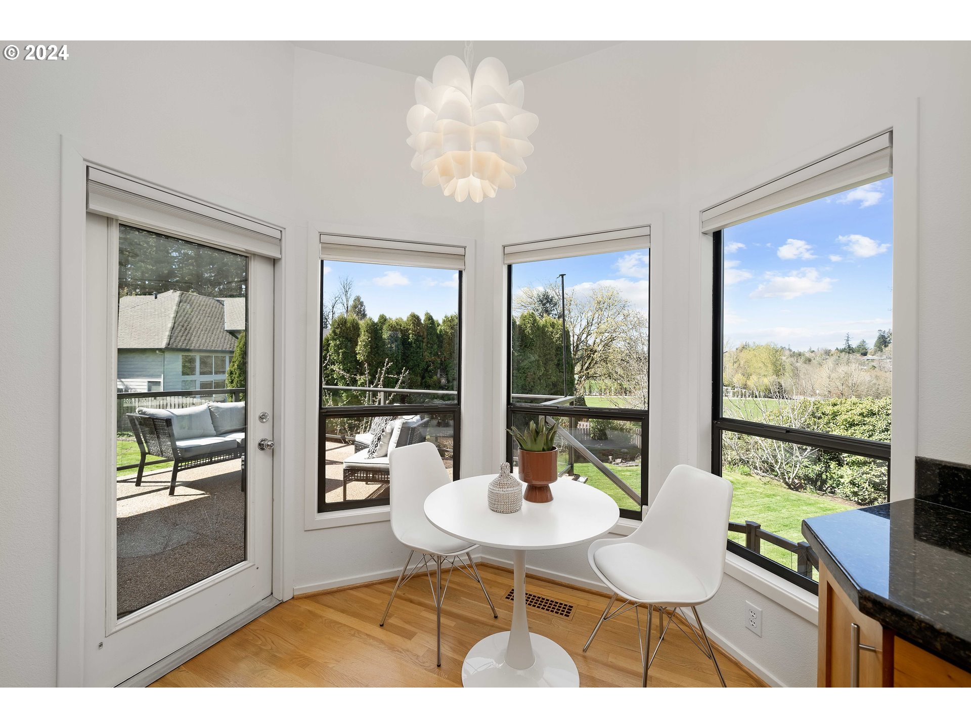 7179 Southwest Arranmore Way Portland, OR 97223 - Photo 17 of 48 a view of a dining room with furniture wooden floor and a chandelier