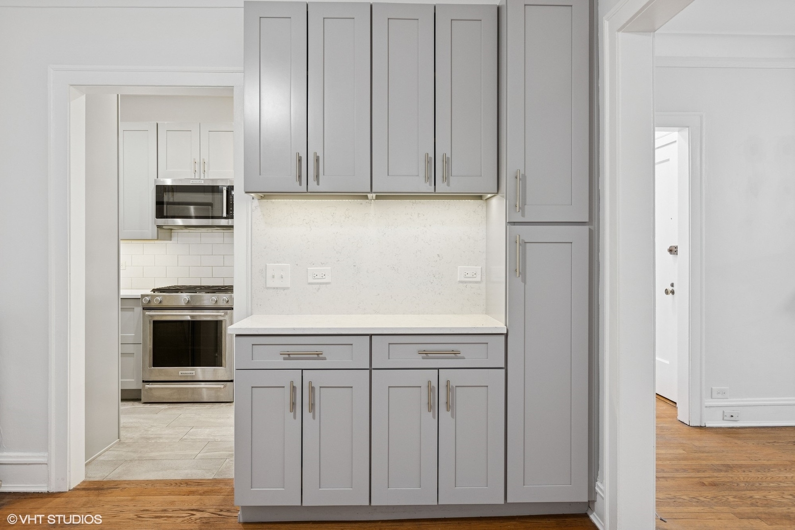 534 West Brompton Avenue, Unit 1N Chicago, IL 60657 - Photo 8 of 20 a kitchen with white cabinets and stainless steel appliances