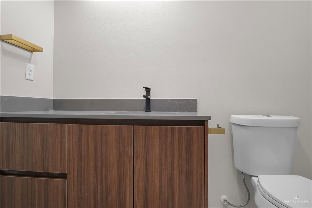 2204 Corales Street Mission, TX 78573 - Photo 14 of 30 a bathroom with a toilet and a sink